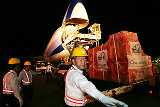 Airport workers load up a cargo plane from China Airlines, Taiwans largest air carrier, at Taiwans international airport in Taipei July 19, 2006.