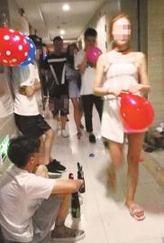 小贩蹲在写字楼楼道里贩卖“气球”,而来来往往的年轻人都喜欢“吹气球”。