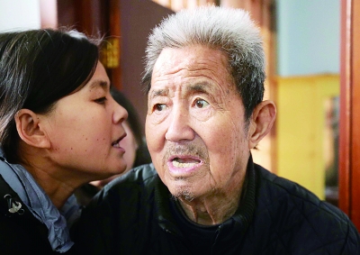 与多年患病的郭建民交流,每一句都需先经小女儿转述 摄/法制晚报记者 田宝希