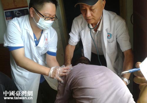 台湾阳明医学院神经内科教授贾力耕博士(右)正在为村民进行诊治 台湾阳明医学院神经内科教授贾力耕博士(右)正在为村民进行诊治