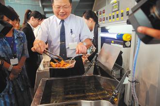 台“中研院”将技术转用民生领域，利用炸油锅的热能发电，可以提供摊位所需风扇、电灯的电力，不必另行充电，还可降低油锅散热，每套成本只要新台币1万元出头。 图片来源：台湾《联合报》